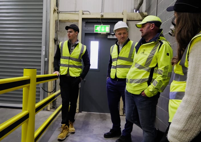Four stakeholders reviewing polymer safety barriers on site during a walkthrough