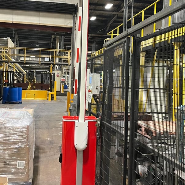 Safety barriers segregating machinery from pedestrian routes in UK industrial facility