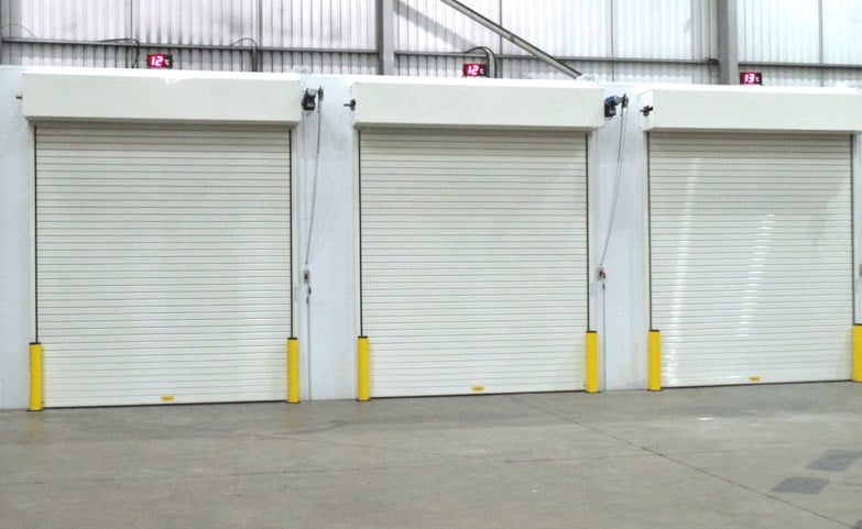 Warehouse raised loading bay platform with closed roller shutter doors