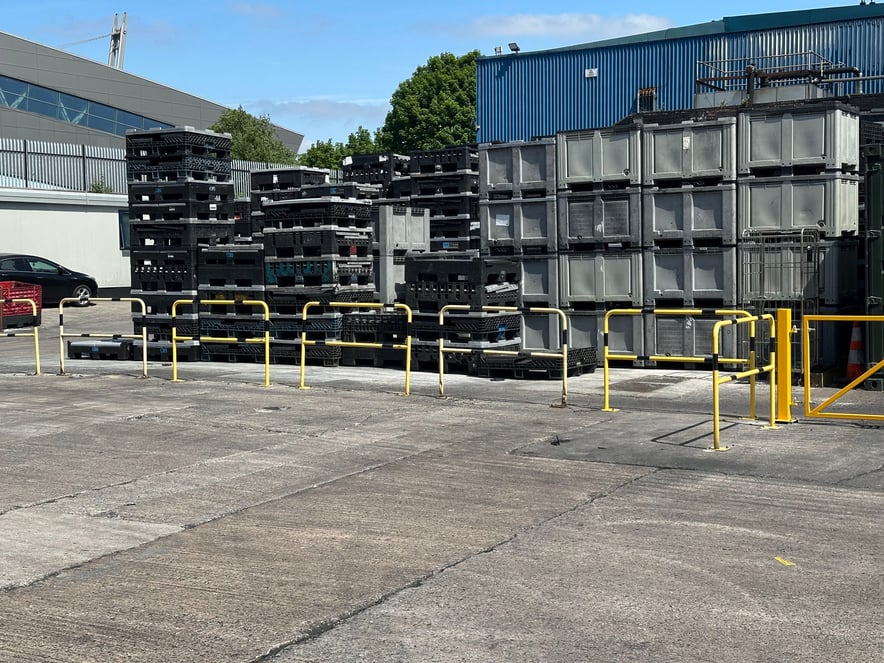 Poorly positioned warehouse barriers creating blind corner safety hazard for pedestrians