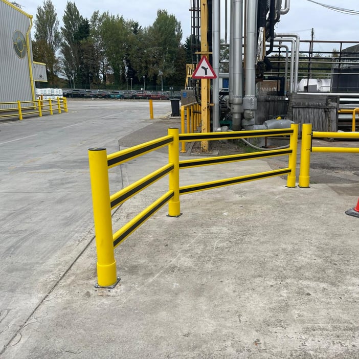 Outdoor polymer safety barriers segregating a vehicle yard from a pedestrian route