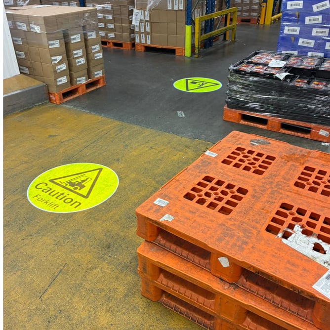 Pallet storage area with LED projected floor markings warning of FLT movement