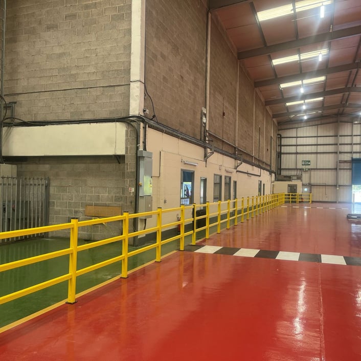 Indoor polymer safety barriers with an integrated pedestrian gate segregating a warehouse walkway