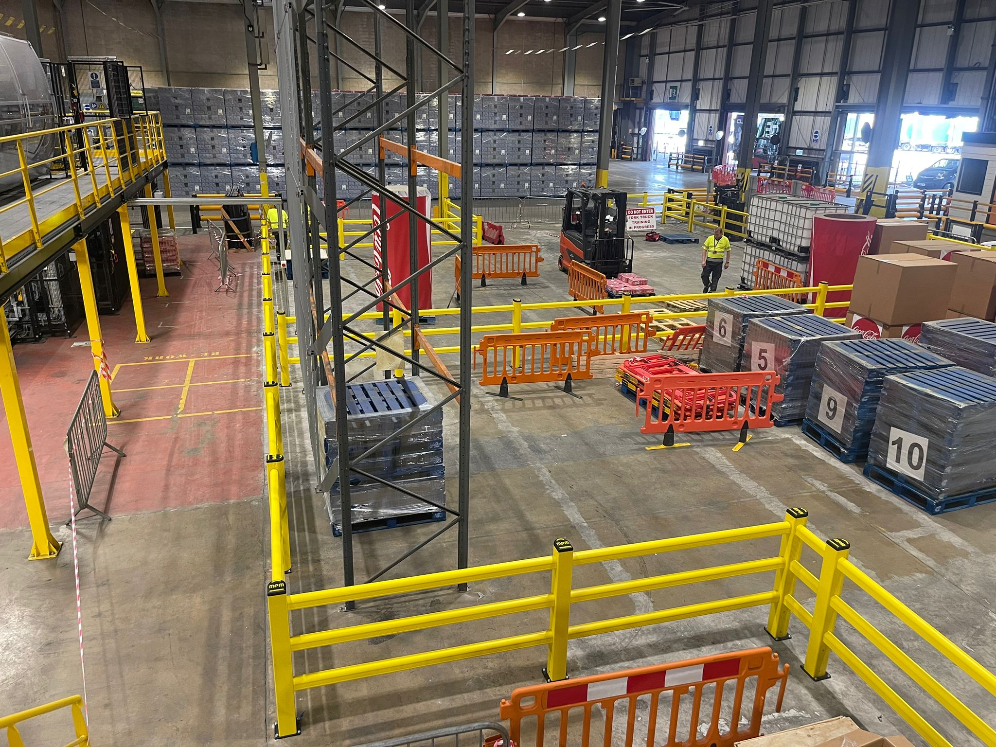 Professional installation of modular polymer safety barriers in UK warehouse facility