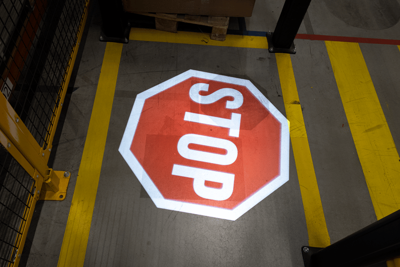 LED projected floor marking stop sign warning forklift drivers at pedestrian crossing in UK warehouse3 / 3