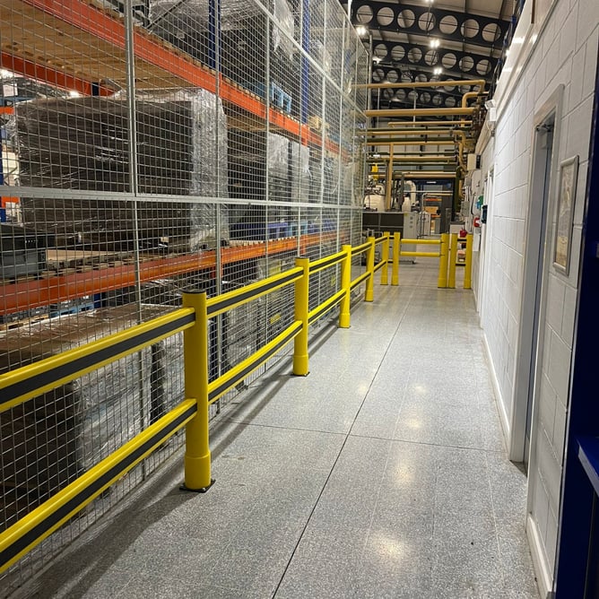 Pedestrian segregation barriers with integrated safety gate in automotive manufacturing plant