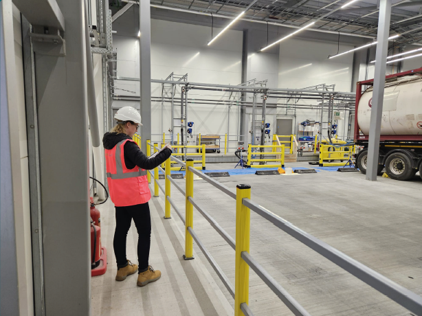 EHS manager reviewing pedestrian walkway segregation in a warehouse loading bay area