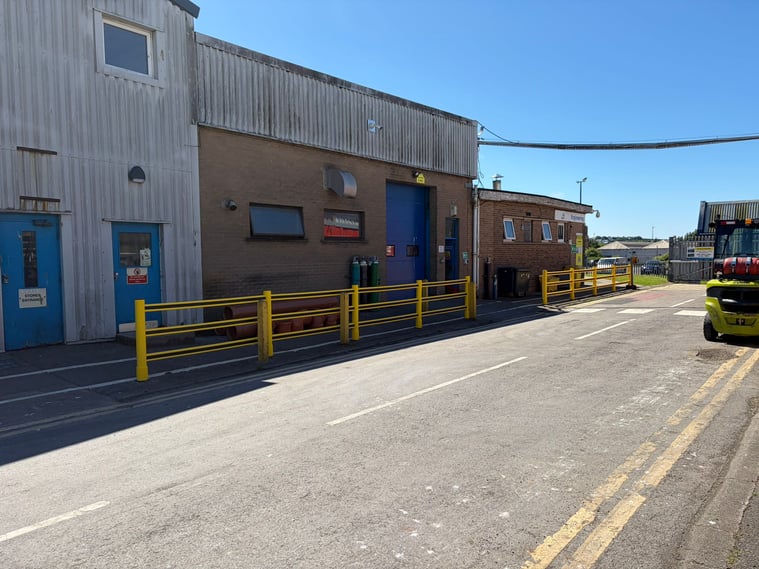 External pedestrian walkway segregated from the vehicle yard by polymer safety barriers