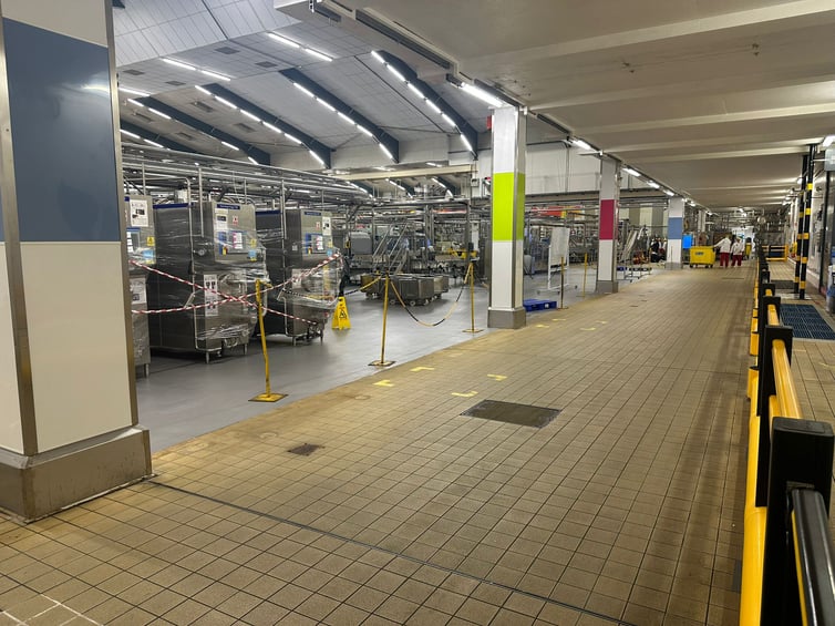 Industrial facility with polymer safety barriers and machinery guarding in production area