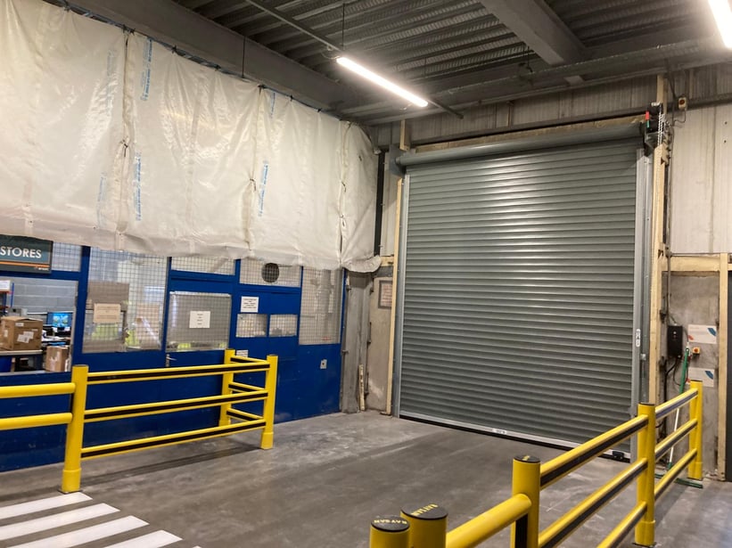 Safety barriers protecting roller door area in warehouse with pedestrian segregation