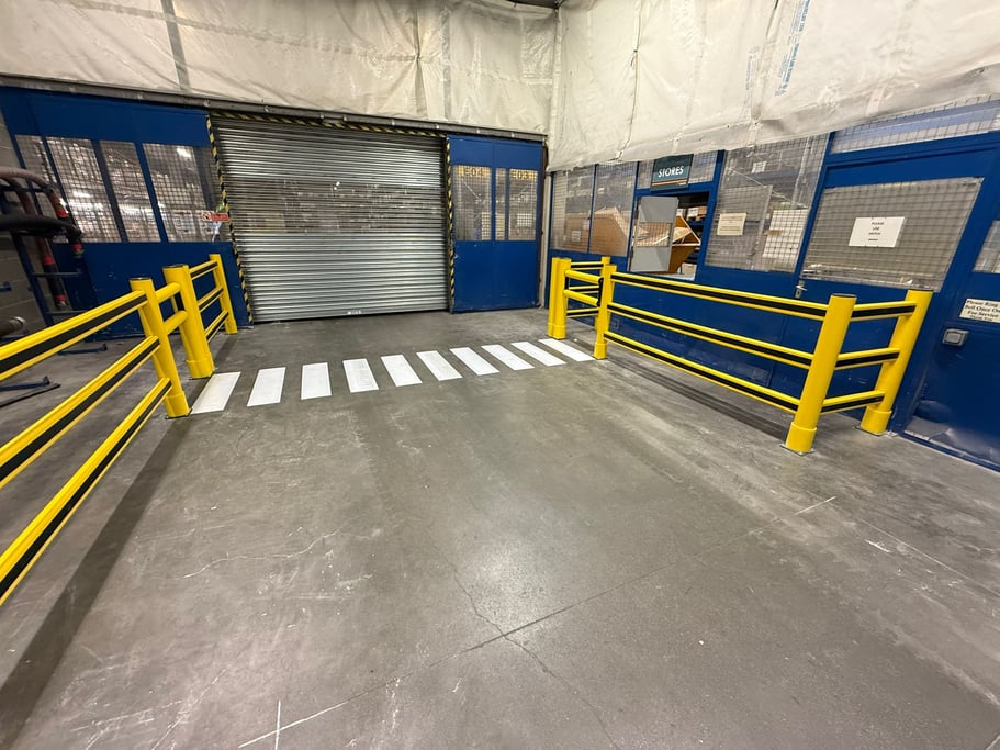 Polymer safety barriers protecting pedestrian walkway in UK warehouse