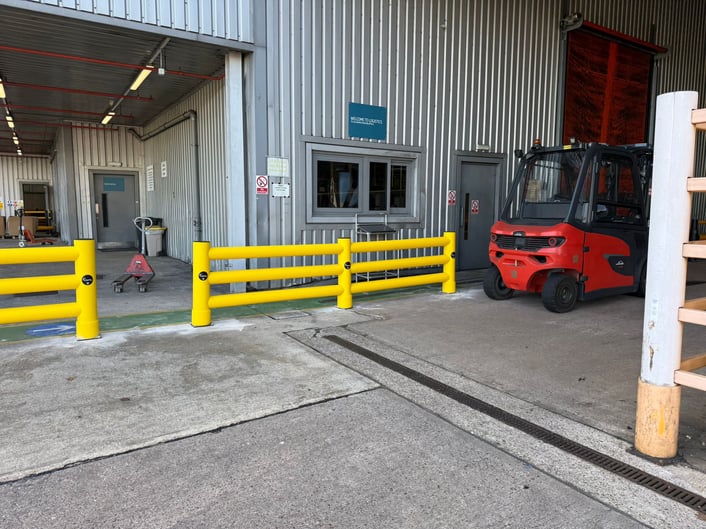 Polymer safety barriers separating a pedestrian walkway from an FLT route in a UK warehouse