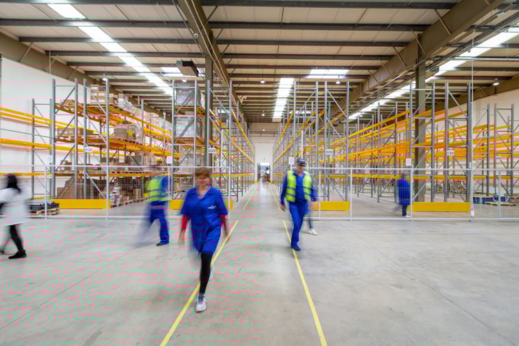Pedestrians ignoring floor walkway markings in active warehouse environment