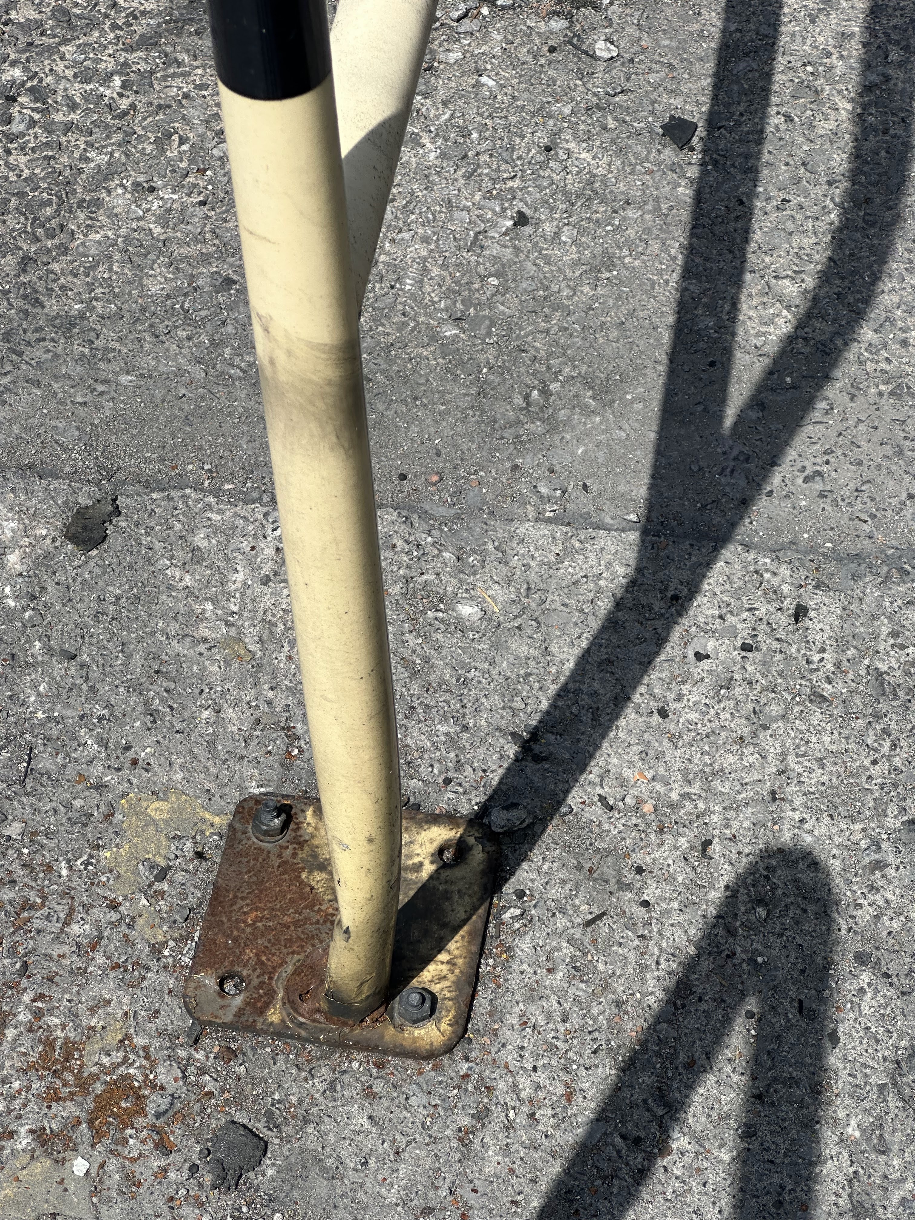 Close-up of rusted steel barrier showing corrosion damage