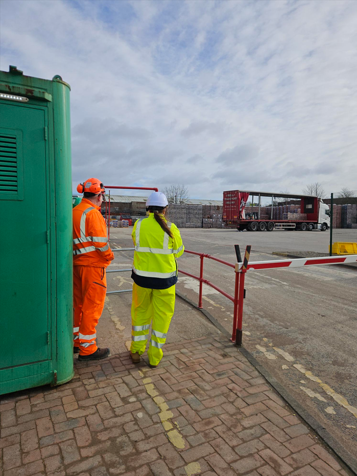Large warehouse safety sign mounted on wall displaying hazard warnings and safety procedures