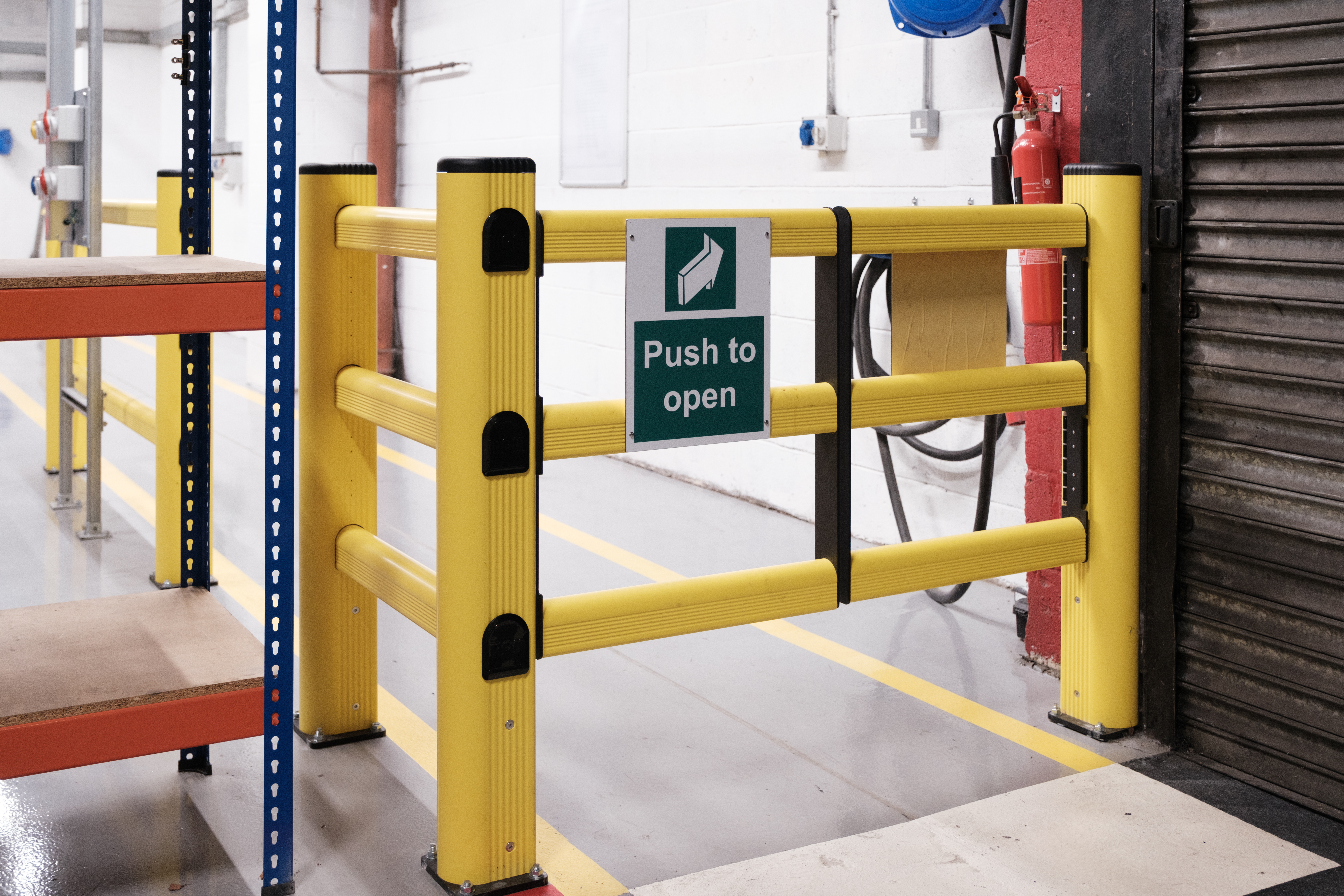Warehouse safety barrier separating forklift and pedestrians