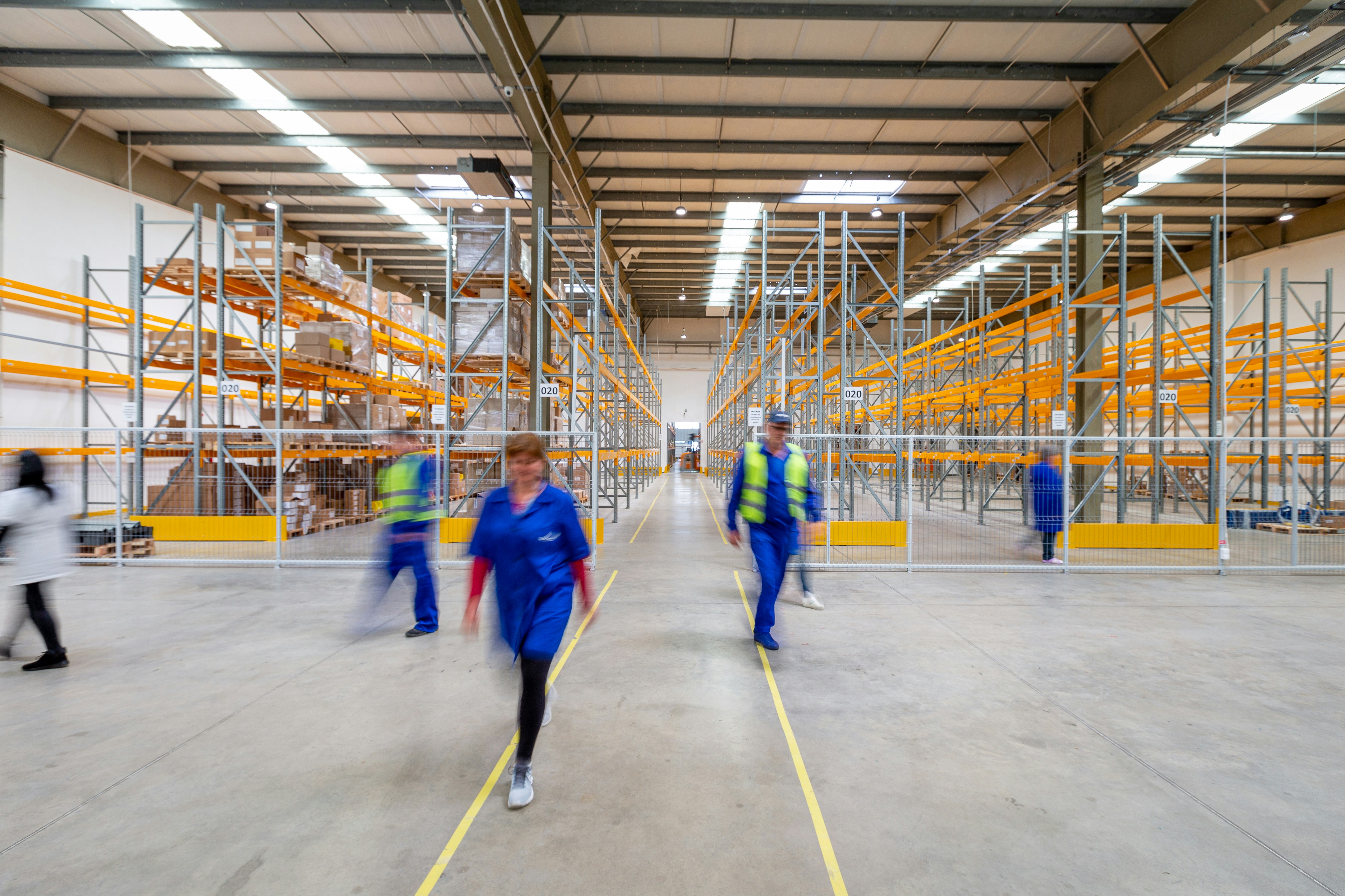 Pedestrians ignoring floor walkway markings in active warehouse environment